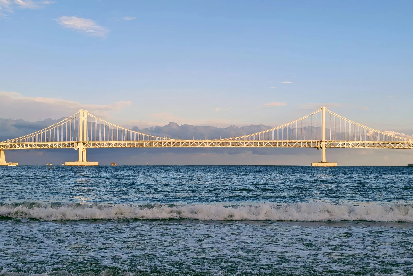 A suspension bridge and waves off the Busan coast