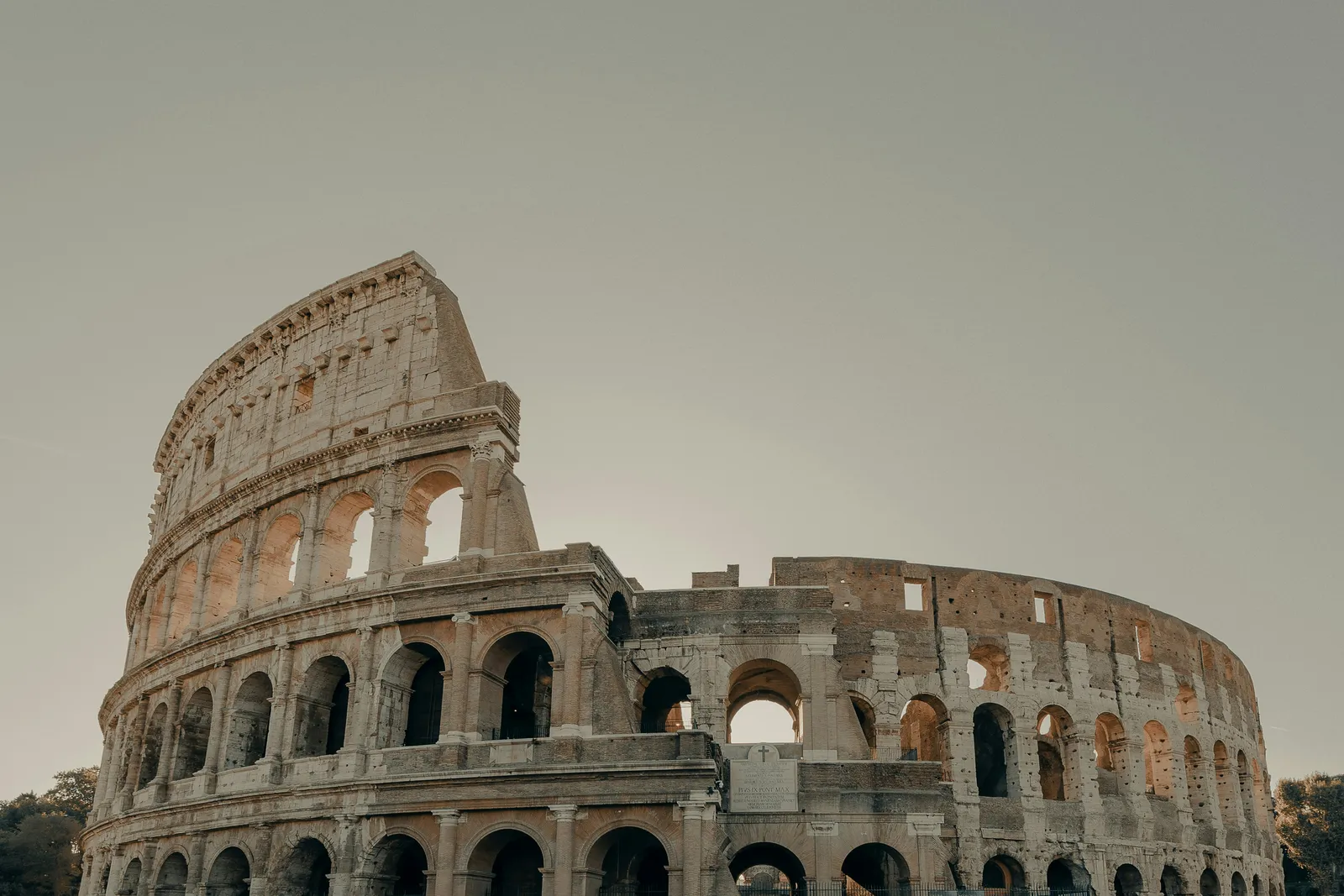 The Colosseum in Rome under a soft grey sky